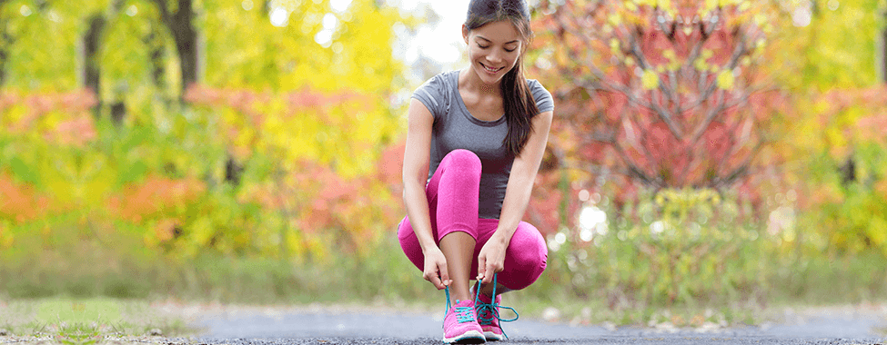 Girl Lacing Up Shoes to Run in Spring