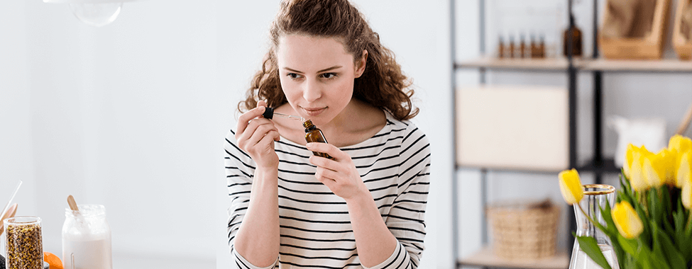 Woman Smelling Essential Oils