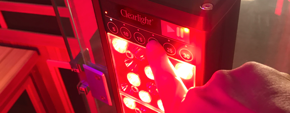 Person Using Clearlight Red Light Therapy Tower