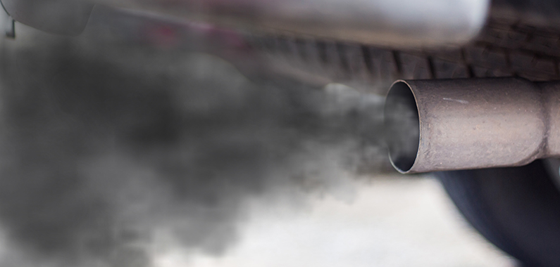 combustion fumes coming out of car exhaust pipe