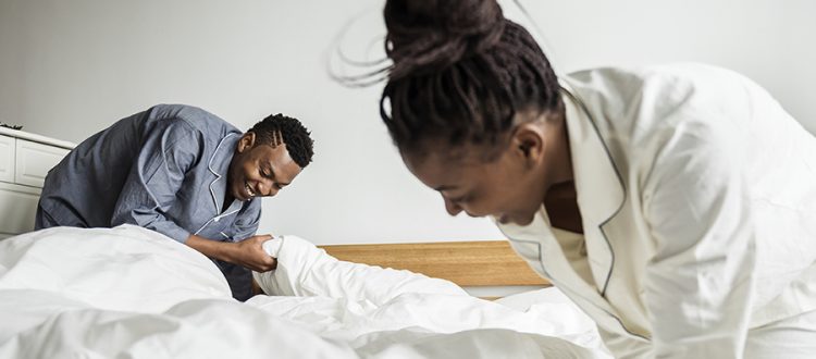 couple making bed