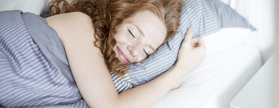 Woman-Sleeping-Happily-in-Bed