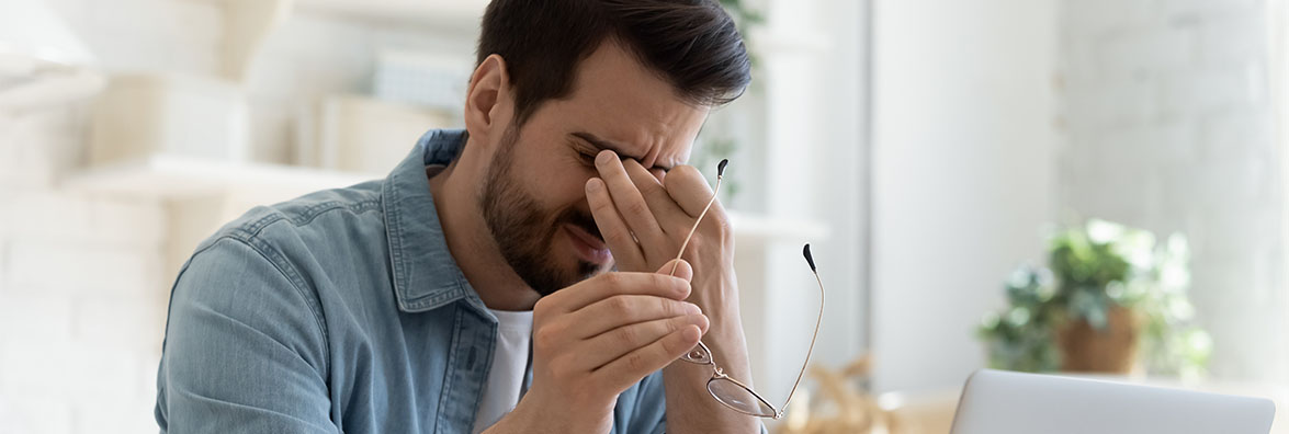 Man pinching nose