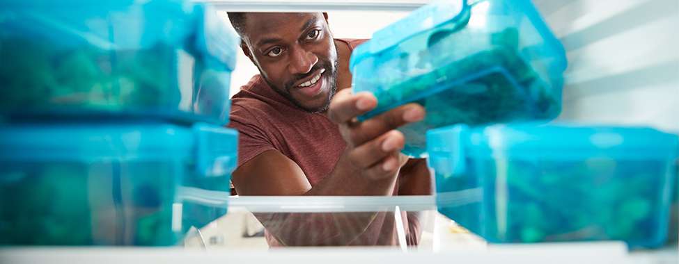 Man Working from Home and Eating Meal Prepped Food