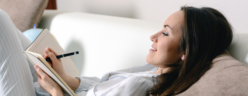 Woman Writing in Journal Before Bed for Mental Health