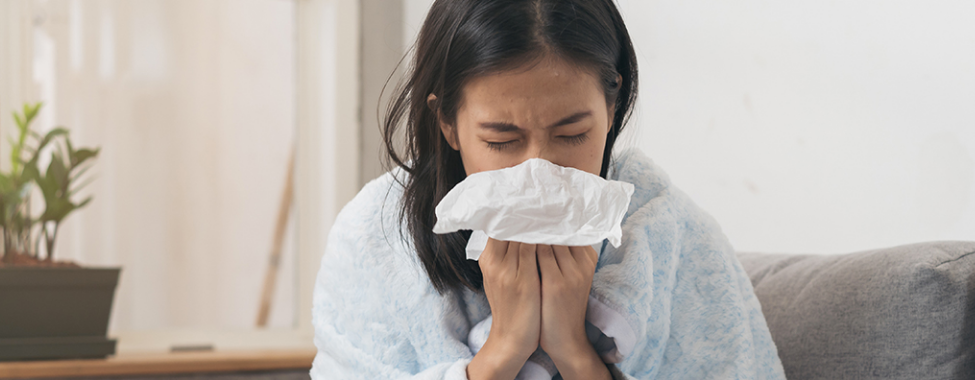 Woman Blowing Nose from Common Cold Symptoms