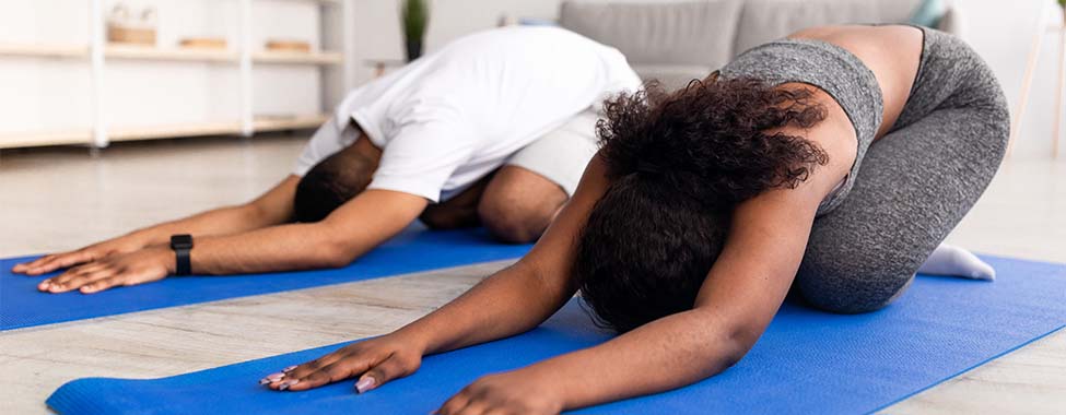 Couple Doing Half Tortoise Pose for Hot Yoga at Home
