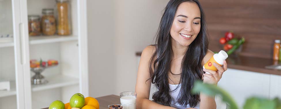 Woman Taking Supplements for Immune Health