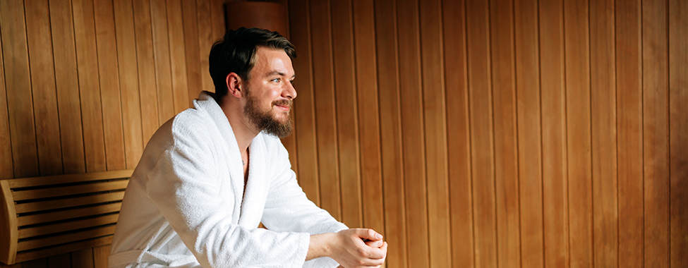 Man Using Infrared Sauna to Naturally Increase Body Heat