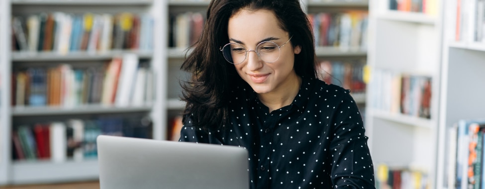Woman Reading Health and Wellness Blog on Computer