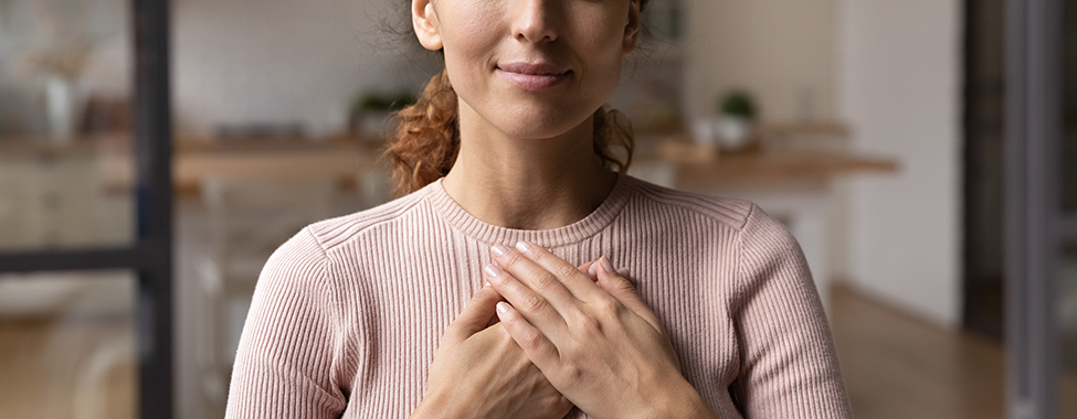 Happy Woman with Hands Over Heart