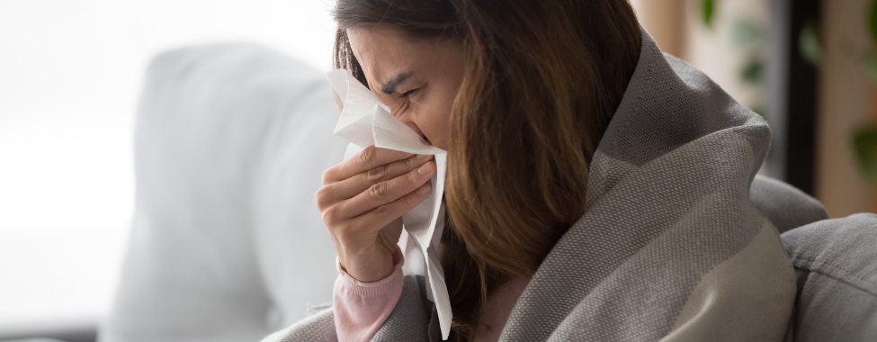 Woman Blowing Nose While Sick