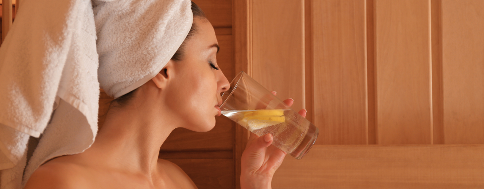 Woman Staying Hydrated in Infrared Sauna When Sick