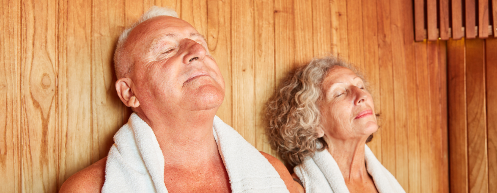 Three Mature Women Wearing Towels Sitting In A Sauna High-Res