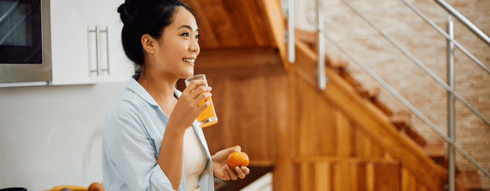 Woman Drinking Orange Juice with Vitamin C for Immunity Boost