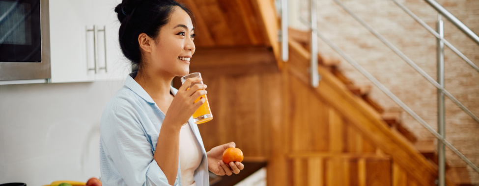 Woman Drinking Orange Juice with Vitamin C for Immunity Boost