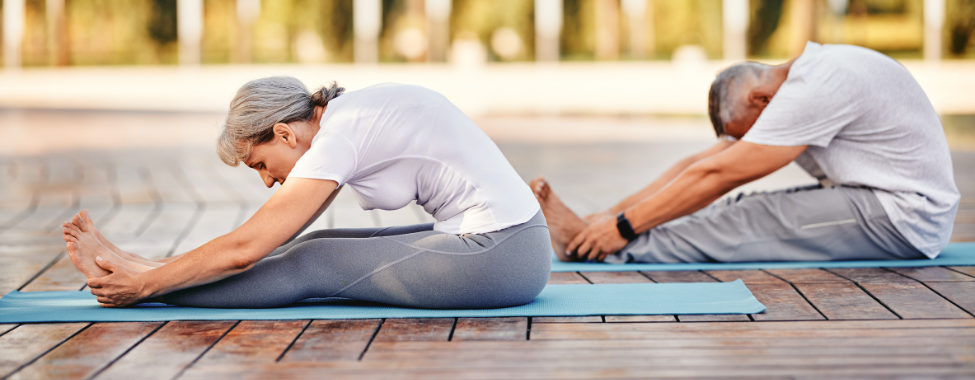 Older Couple Doing Yoga Exercises to Improve Mobility Naturally