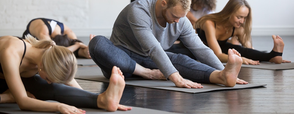 Group of People Taking Yoga Class in Yoga Studio
