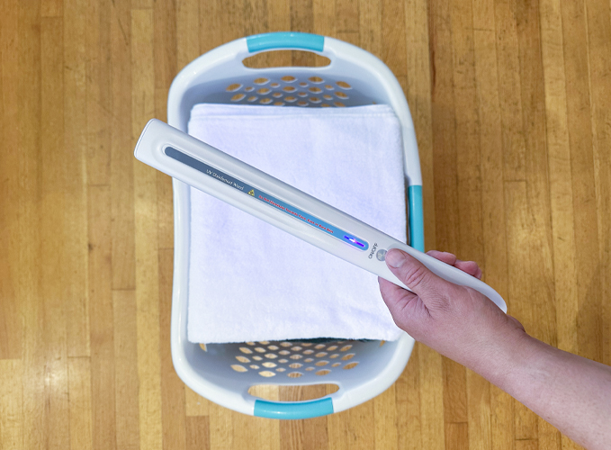 white uv wand over laundry for disinfecting