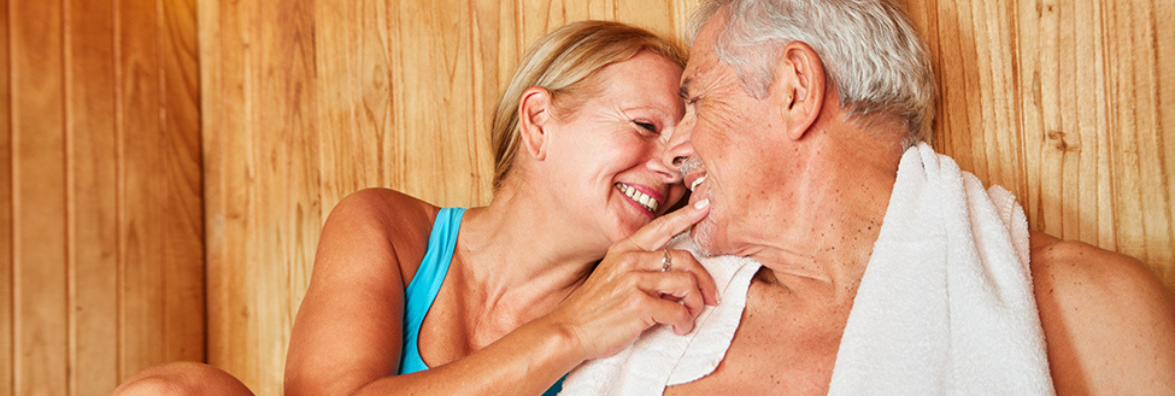 Happy Couple Using Infrared Sauna for Mental Health Benefits