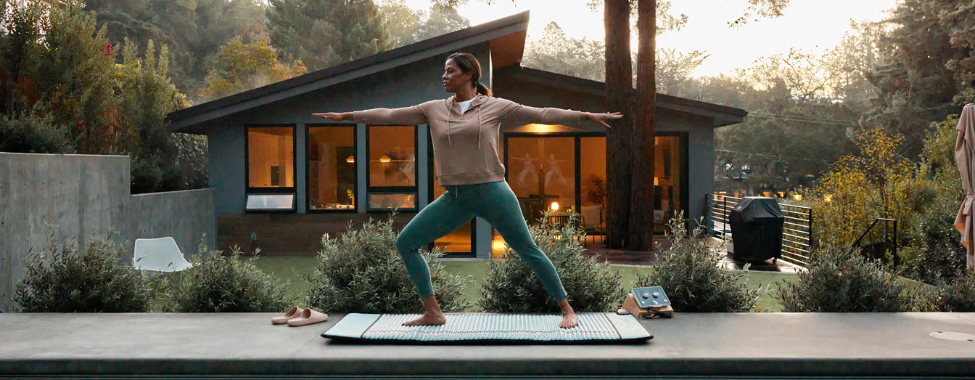 Woman Using Clearlight PEMF Mat at Vacation Rental Home