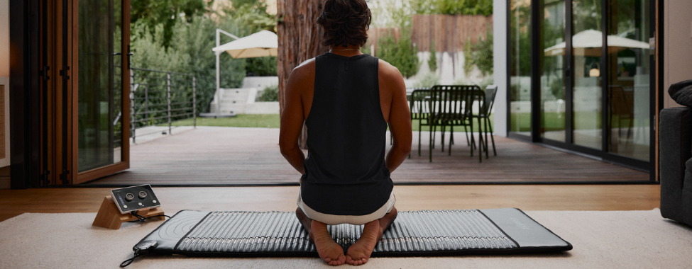 Man Meditating on Clearlight PEMF Mat During Health Routine