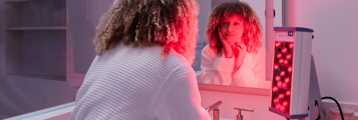 Woman Using Clearlight Red Light PERSONAL Tower in Bathroom