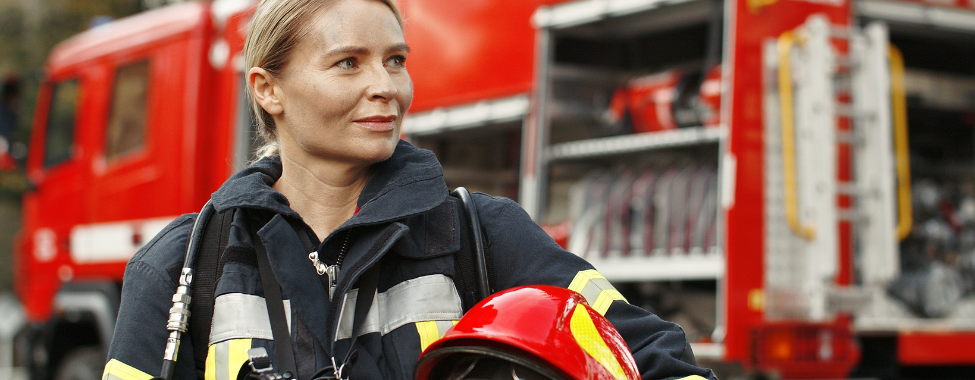 Woman Dressed in Full Firefighter Uniform