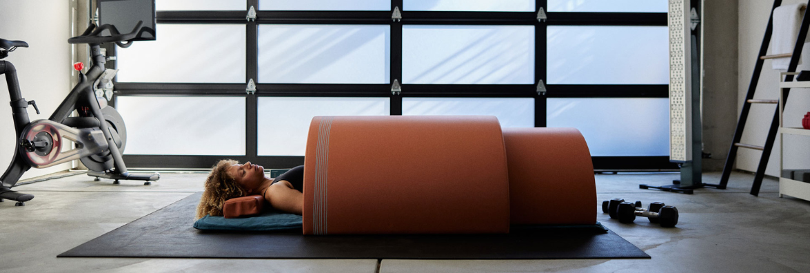 Woman Using Clearlight Infrared Sauna Dome in Home Gym