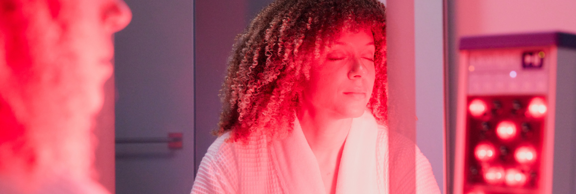 Woman Using Clearlight Red Light Tower for Healthy Skin