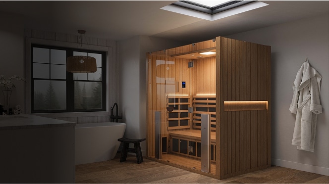 A Clearlight sauna indoors in a darkened space with the saunas lights on