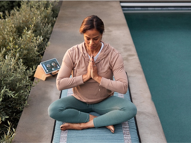 Woman sitting in a meditating pose