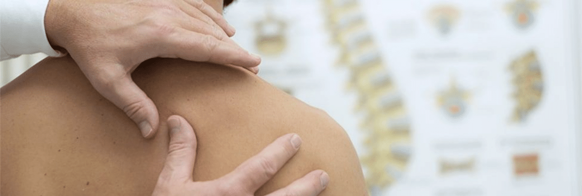 Chiropractor Checking Patient in Chiropractic Office
