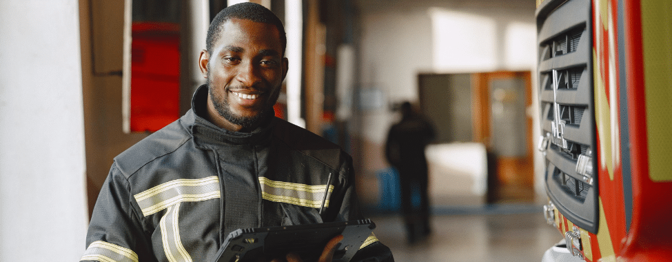 Happy Firefighter Near Fire Truck
